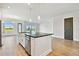 Spacious open-concept kitchen with a large island, stainless steel appliances, and a view at 18096 Foxtail Loop, Venice, FL 34293