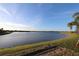 Beautiful waterfront lot with expansive lake view and manicured green lawn at 18096 Foxtail Loop, Venice, FL 34293
