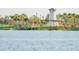 Scenic lakefront amenity with a dock, gazebo, and seating, perfect for relaxation and enjoying nature at 18096 Foxtail Loop, Venice, FL 34293