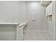 Functional laundry room with ample counter space and upper cabinets at 18096 Foxtail Loop, Venice, FL 34293