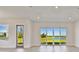 Bright living room with large windows overlooking a green space at 18096 Foxtail Loop, Venice, FL 34293