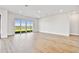 Spacious living room featuring wood floors and sliding glass doors at 18096 Foxtail Loop, Venice, FL 34293