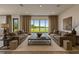 Bright living room showcasing two sofas, a large rug and picturesque outdoor views at 18096 Foxtail Loop, Venice, FL 34293