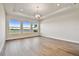 Well-lit open living room with wood floors and windows with water views at 18096 Foxtail Loop, Venice, FL 34293