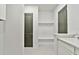 Well-organized mud room with storage shelves and a convenient sink at 18096 Foxtail Loop, Venice, FL 34293