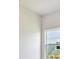 Bright empty room with fresh paint, light streaming through a window, and new landscaping outside at 18096 Foxtail Loop, Venice, FL 34293