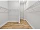 Spacious walk-in closet with wire shelving and light wood flooring provides ample storage space at 18096 Foxtail Loop, Venice, FL 34293