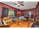 Living room with hardwood floors, gray sectional sofa and a ceiling fan at 1840 21St N Ave, St Petersburg, FL 33713
