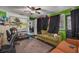 Spacious living area with green walls, couch, and musical instruments at 1840 21St N Ave, St Petersburg, FL 33713