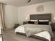 King bedroom with wood headboard and soft textiles at 29254 Bay Hollow Dr # 3262, Wesley Chapel, FL 33543