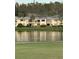 Condo building with water view and reflection at 29254 Bay Hollow Dr # 3262, Wesley Chapel, FL 33543
