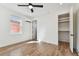 Well-lit bedroom featuring wood floors, a ceiling fan and closet at 3035 1St S Ave, St Petersburg, FL 33712