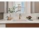 Kitchen counter with a marble countertop, a stainless steel faucet, and a white backsplash at 3035 1St S Ave, St Petersburg, FL 33712