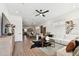 Spacious living room featuring a ceiling fan, hardwood floors, and a dining area in the background at 3035 1St S Ave, St Petersburg, FL 33712