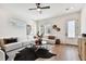 Comfortable living room featuring hardwood floors, a ceiling fan, and stylish, modern decor at 3035 1St S Ave, St Petersburg, FL 33712