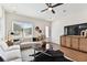 Modern living room featuring a sectional sofa, hardwood floors, and a large TV at 3035 1St S Ave, St Petersburg, FL 33712