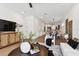 Open living space with hardwood floors, a large sectional sofa, and a view into the kitchen at 3035 1St S Ave, St Petersburg, FL 33712