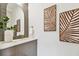 Stylish bathroom with marble vanity, arched mirror, and geometric tile at 3035 1St S Ave, St Petersburg, FL 33712