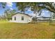 Side view of a white brick home with fenced pool and large yard at 4401 Platt Rd, Plant City, FL 33565