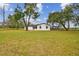 White brick ranch house with large yard, and a screened pool at 4401 Platt Rd, Plant City, FL 33565