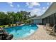 Enjoyable kidney-shaped pool with brick pavers and tropical landscaping at 5104 W San Jose St, Tampa, FL 33629