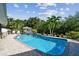 Inviting kidney-shaped pool with brick pavers and tropical landscaping at 5104 W San Jose St, Tampa, FL 33629