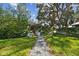 Stone pathway leading to waterfront access through lush greenery at 5104 W San Jose St, Tampa, FL 33629