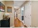 Long hallway with hardwood floors and access to bathroom and other rooms at 5479 Blue Heron Ln, Wesley Chapel, FL 33543