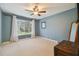 Spacious bedroom with ceiling fan and large window at 5479 Blue Heron Ln, Wesley Chapel, FL 33543