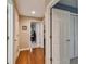 Bright hallway with hardwood floors and access to bedrooms and office at 5479 Blue Heron Ln, Wesley Chapel, FL 33543