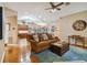 Open living room with hardwood floors and views into kitchen area at 5479 Blue Heron Ln, Wesley Chapel, FL 33543