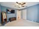 Bright bedroom featuring a large TV and ample closet space at 5479 Blue Heron Ln, Wesley Chapel, FL 33543
