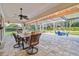 Covered patio with dining table and string lights at 5479 Blue Heron Ln, Wesley Chapel, FL 33543