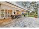 Enjoy this paved patio with seating, string lights and a view of the backyard at 5479 Blue Heron Ln, Wesley Chapel, FL 33543