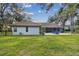 House exterior view showcasing the lawn, fence, and patio area at 5479 Blue Heron Ln, Wesley Chapel, FL 33543