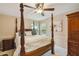 Primary bedroom with a large four-poster bed and plenty of natural light at 5479 Blue Heron Ln, Wesley Chapel, FL 33543