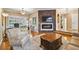 Spacious living room featuring a fireplace, hardwood floors, and ample natural light at 5479 Blue Heron Ln, Wesley Chapel, FL 33543