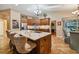 Open kitchen with island, breakfast bar, stainless steel appliances, and view to Gathering room at 5479 Blue Heron Ln, Wesley Chapel, FL 33543