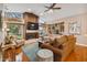 Spacious living room with hardwood floors, fireplace and built-in shelving at 5479 Blue Heron Ln, Wesley Chapel, FL 33543