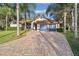 Beautiful home with tile roof, blue garage door, and brick driveway at 5479 Blue Heron Ln, Wesley Chapel, FL 33543