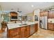 Gourmet kitchen boasts a large island, stainless steel appliances, and custom cabinetry at 5479 Blue Heron Ln, Wesley Chapel, FL 33543