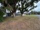 Aerial view of a home with a spacious yard and tree at 5904 16Th St, Zephyrhills, FL 33542