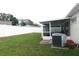 Fenced backyard with lush green grass and a screened-in patio, offering privacy and space at 9708 Little Pond Way, Tampa, FL 33647