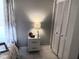 Bedroom detail showcasing a nightstand, closet, and soft natural lighting for a peaceful retreat at 9708 Little Pond Way, Tampa, FL 33647