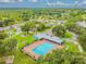 Aerial view showing community pool, surrounding landscaping, and nearby buildings at 9708 Little Pond Way, Tampa, FL 33647