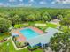 Aerial view of community pool with surrounding landscaping and nearby playground at 9708 Little Pond Way, Tampa, FL 33647