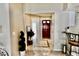 Welcoming foyer with tiled floors and decorative accents leads to the front door at 9708 Little Pond Way, Tampa, FL 33647