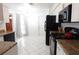 Galley-style kitchen with granite countertops and white cabinets at 9708 Little Pond Way, Tampa, FL 33647