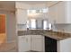 Bright kitchen features granite countertops and white cabinetry at 9708 Little Pond Way, Tampa, FL 33647
