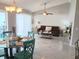 An open-concept living room featuring a dining area with tiled floors and natural light at 9708 Little Pond Way, Tampa, FL 33647